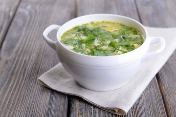 Delicious green soup with sorrel on table close-up