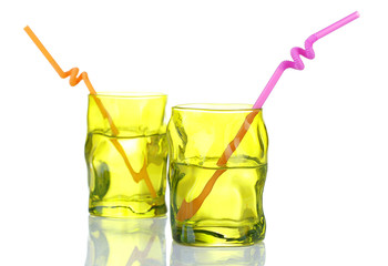 Colorful glasses with cocktail straw isolated on white