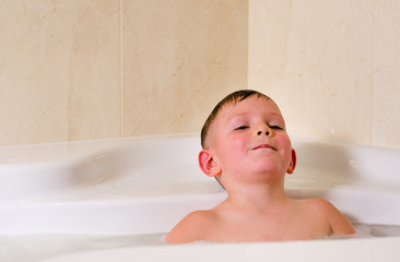 Boy having a relaxing bubble bath
