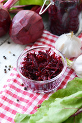 Grated beetroots in bowl on table close-up