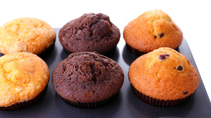 Fresh baked muffins in pan, isolated on white