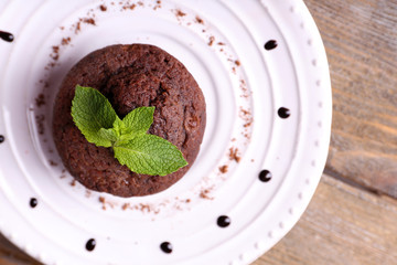 Chocolate muffin on plate wooden background