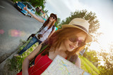 Two Tourist Girl Hitchhiking
