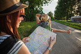 Two Tourist Girl Hitchhiking