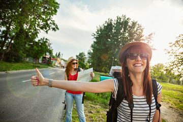 Two Tourist Girl Hitchhiking
