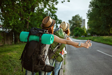 Two Tourist Girls Hitchhiking