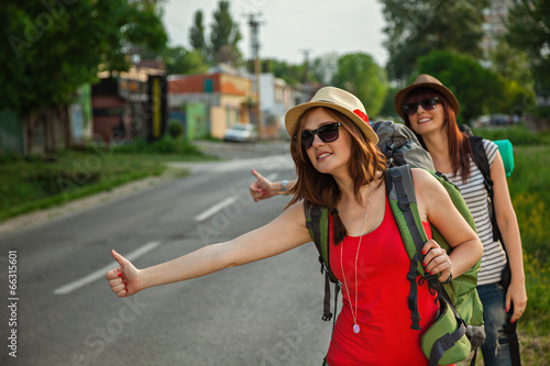 Two Tourist Girls Hitchhiking