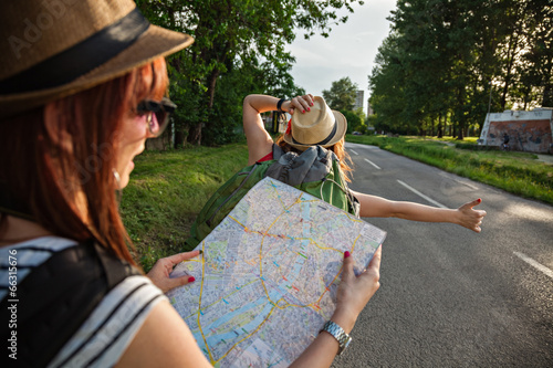 Two Tourist Girl Hitchhiking