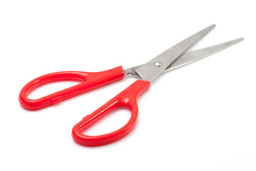 Red scissors on white background