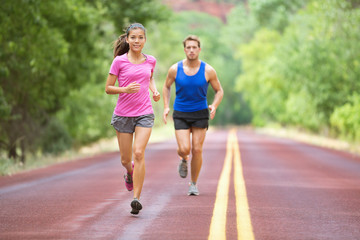 Sport - couple running on road training marathon
