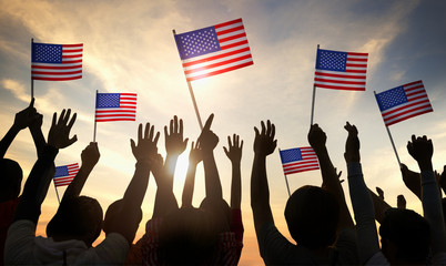 Silhouettes of People Holding the Flag of USA