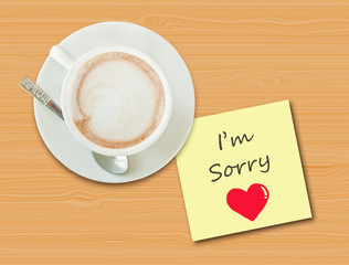 Coffee cup on wood table with paper note