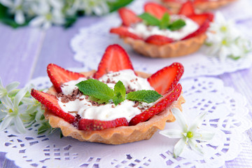 Tasty tartlets with strawberries on table close-up