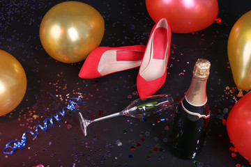 Shoes with confetti, champagne and balloons on the floor