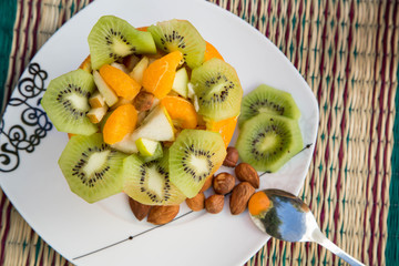 Fruit salad and a glass of fresh orange juice