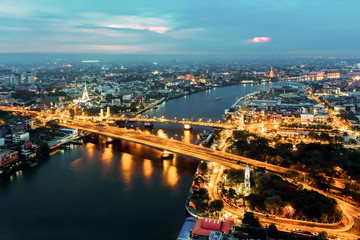 Fototapeta premium Bangkok Transportation at Dusk with the ancient Temple along the