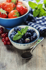 Berries in bowls  on Wooden Background.