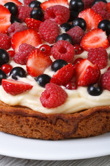 pie with fresh raspberries and strawberries close up vertical