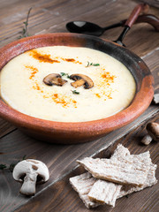 Champignons mushroom soup on a wooden board