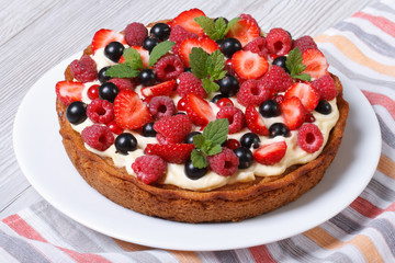berry tart with strawberries, raspberries, currants, mint