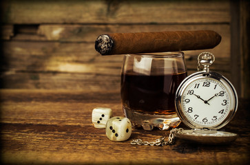 Still life with cognac, cigar , dice and a watch