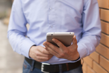 Close up of the hands of the businessman with a tablet PC.