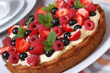 berry pie decorated with strawberries, raspberries, mint