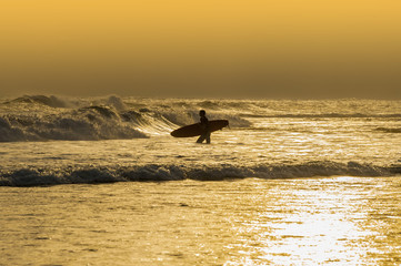 Athletic surfer with board