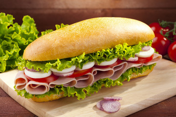 big sandwich with ham, cheese and vegetables