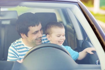 Father and son driving car