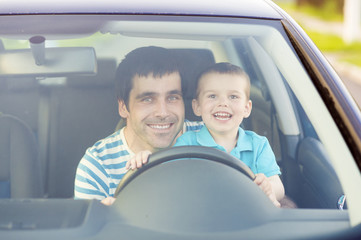 Father and son driving car