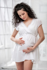 Portrait of the young pregnant woman