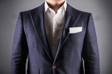 Elegant man wearing formal suit. business card in the pocket