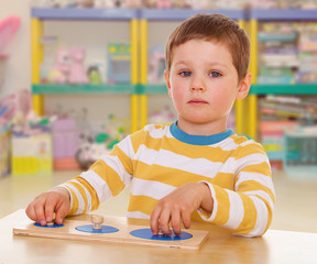 little boy collects a puzzle