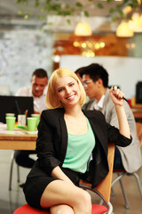 Cheerful businesswoman sitting in office
