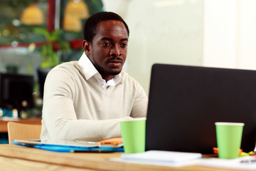 African american businessman working on his laptop in office