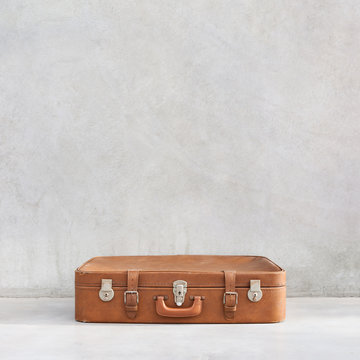 old vintage suitcase in the concrete light room