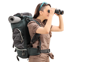 Female hiker looking through binoculars