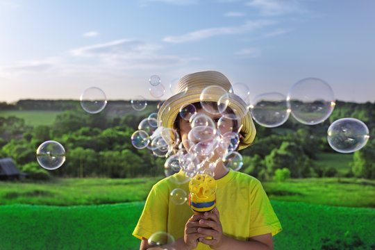 boy play in  bubbles - Powered by Adobe