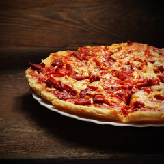 round pizza on wood background