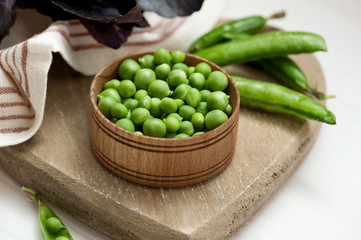 Close-up of green peas on wooden background