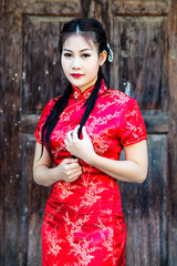 Chinese girl in traditional Chinese cheongsam blessing