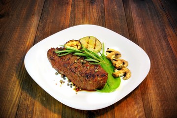 Grilled beef steaks with mushrooms