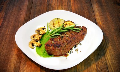 Grilled beef steaks with mushrooms