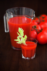 Tomato celery juice in a glass on the table, selective focus
