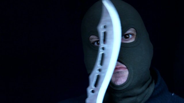 Man in a mask holding knife