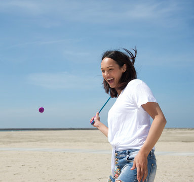 Woman playing tennis at the beach