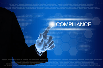 business hand clicking compliance button on touch screen
