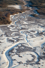 Snow covered plain with river, top view
