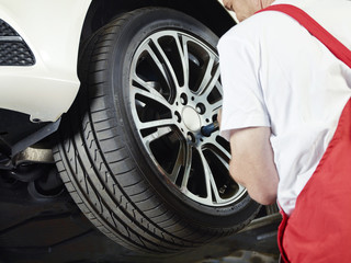 Motor mechanic is changing a tyre